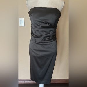 Formal black strapless satin dress with waist details for dimension and to slim.